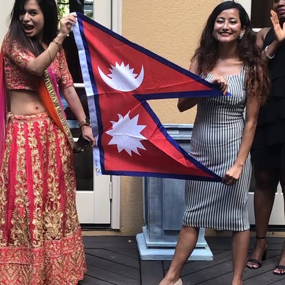 Two Kectil participants smiling together with a Nepal flag.