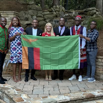 Kectil participants gathered together with a Zambia flag.