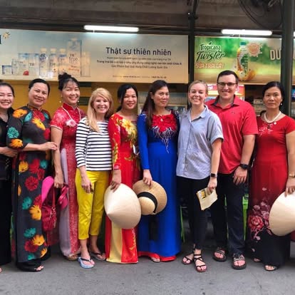 Kectil participants posing together in colorful cultural dress.