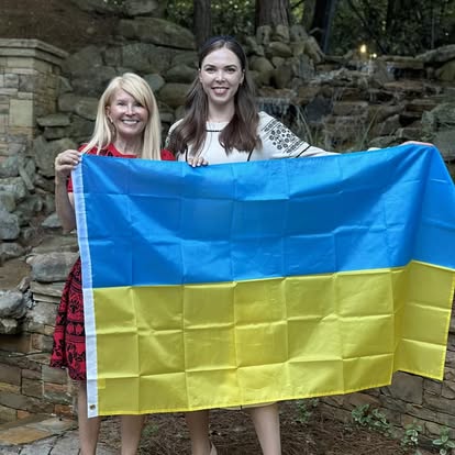 Two Kectil participants smiling together with a Ukraine flag.