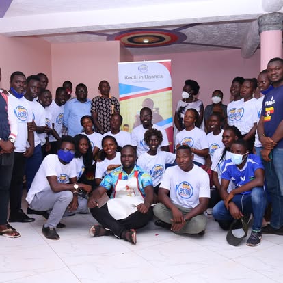 Kectil participants seated together in blue shirts.