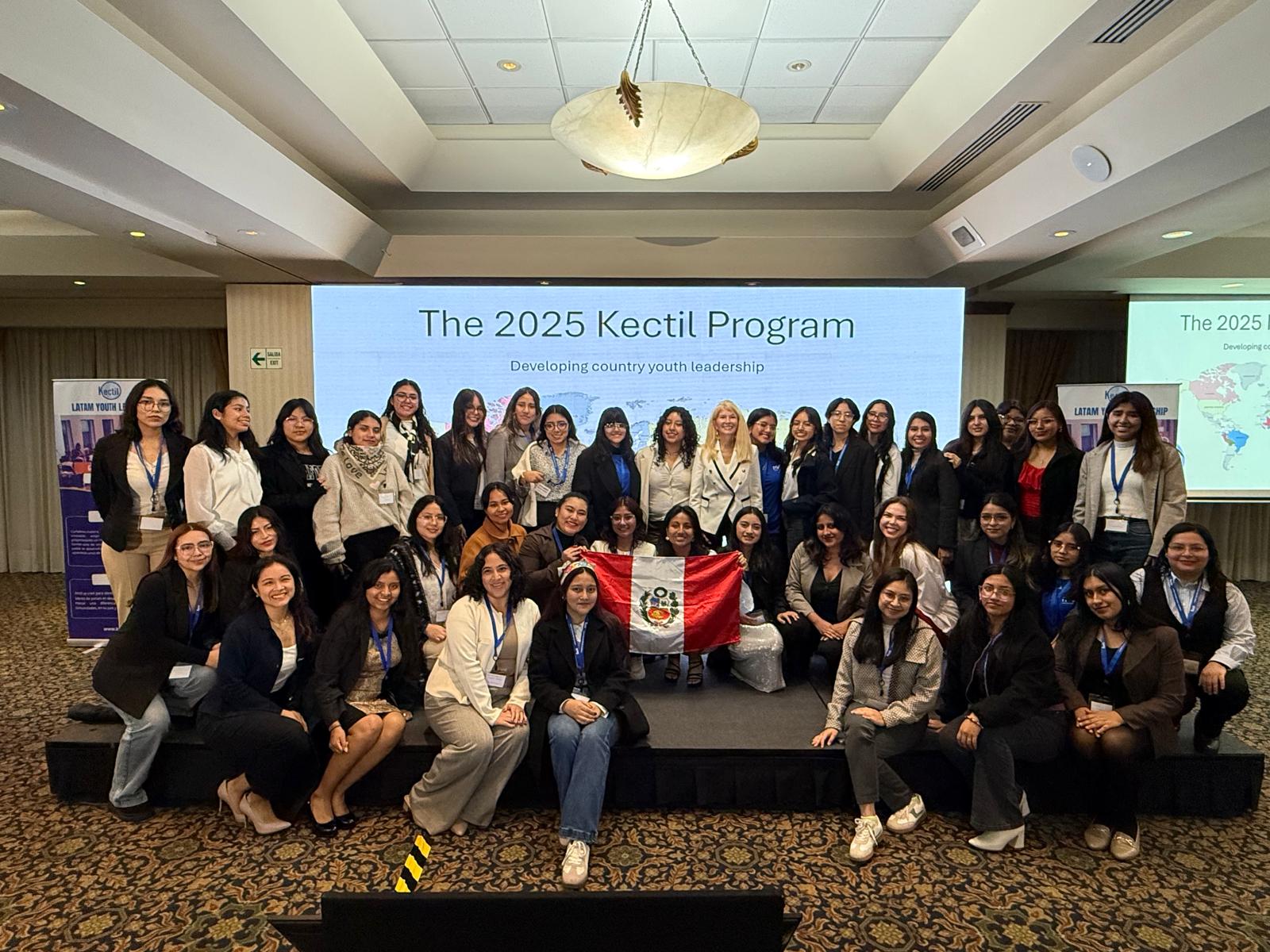 Kectil Latin America group gathered with a Peru flag.