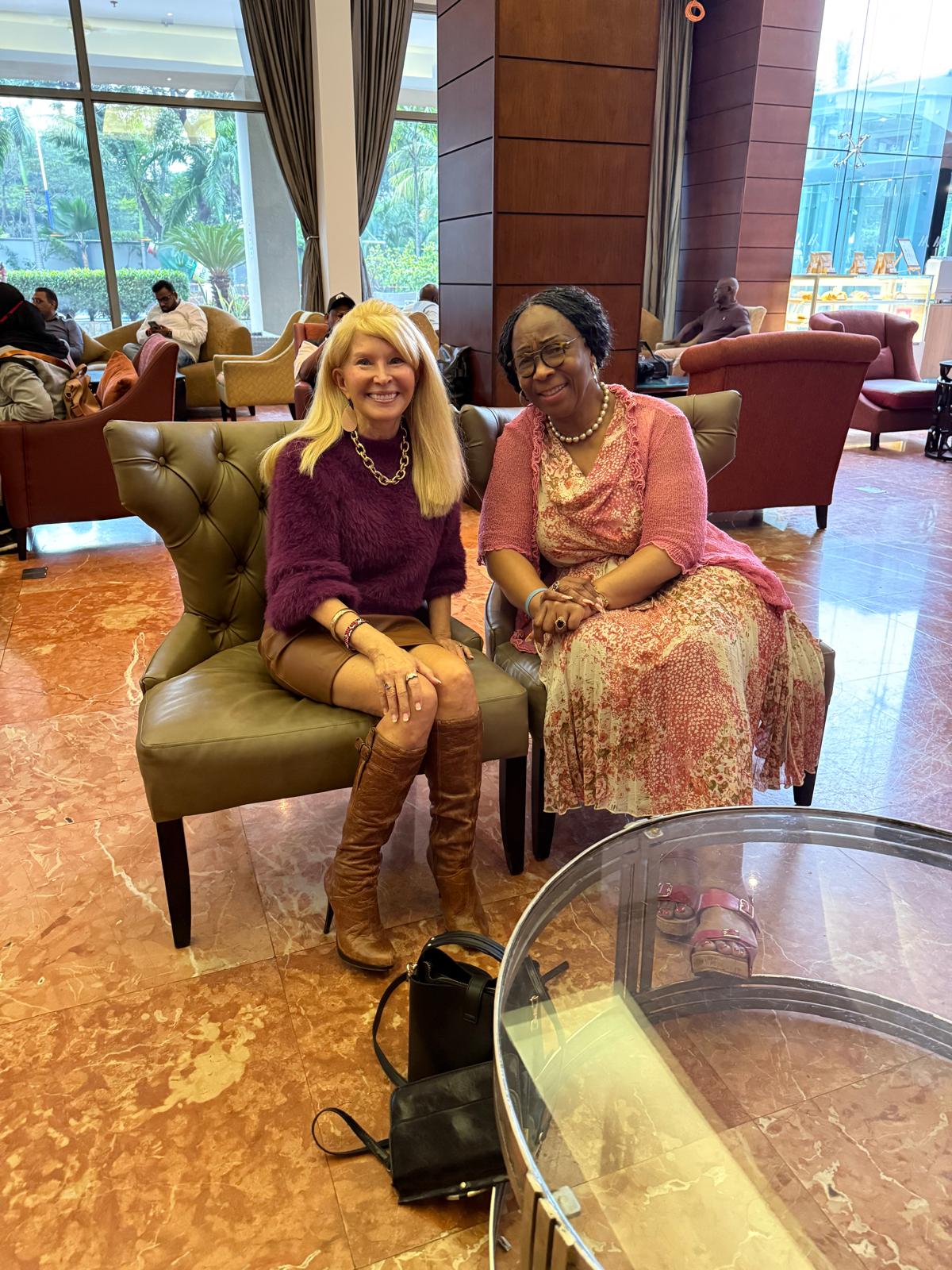 Two Kectil participants seated in a hotel lobby.