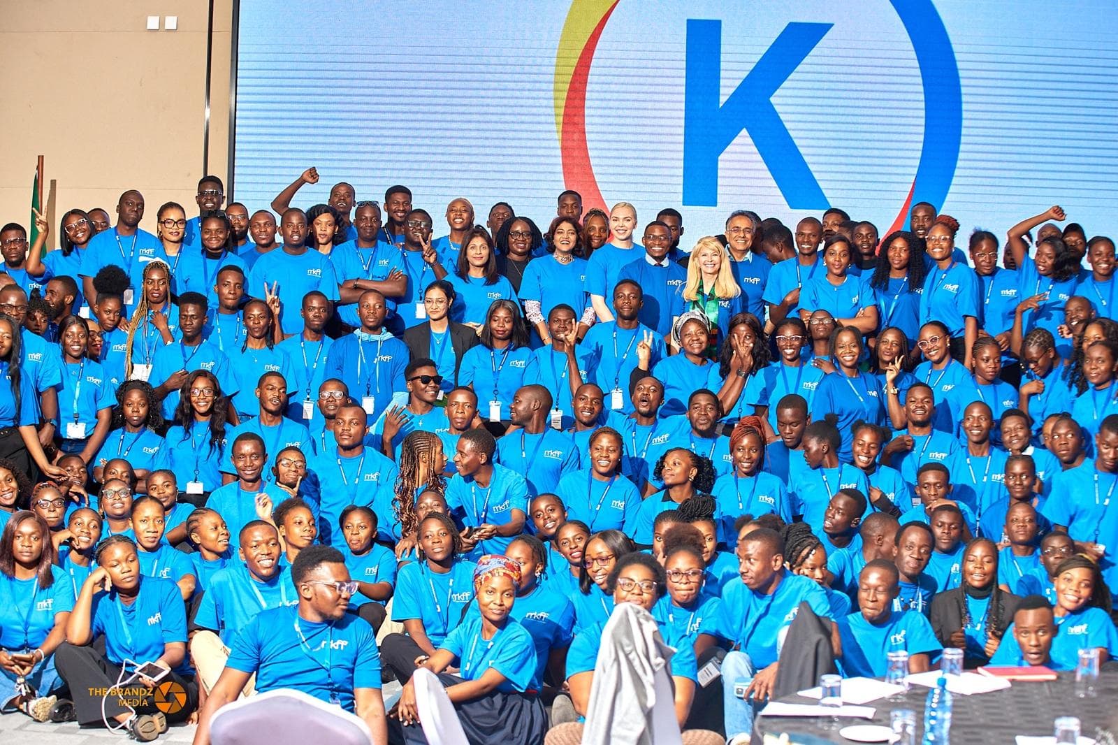 Kectil colleagues seated together in front of the program mark.