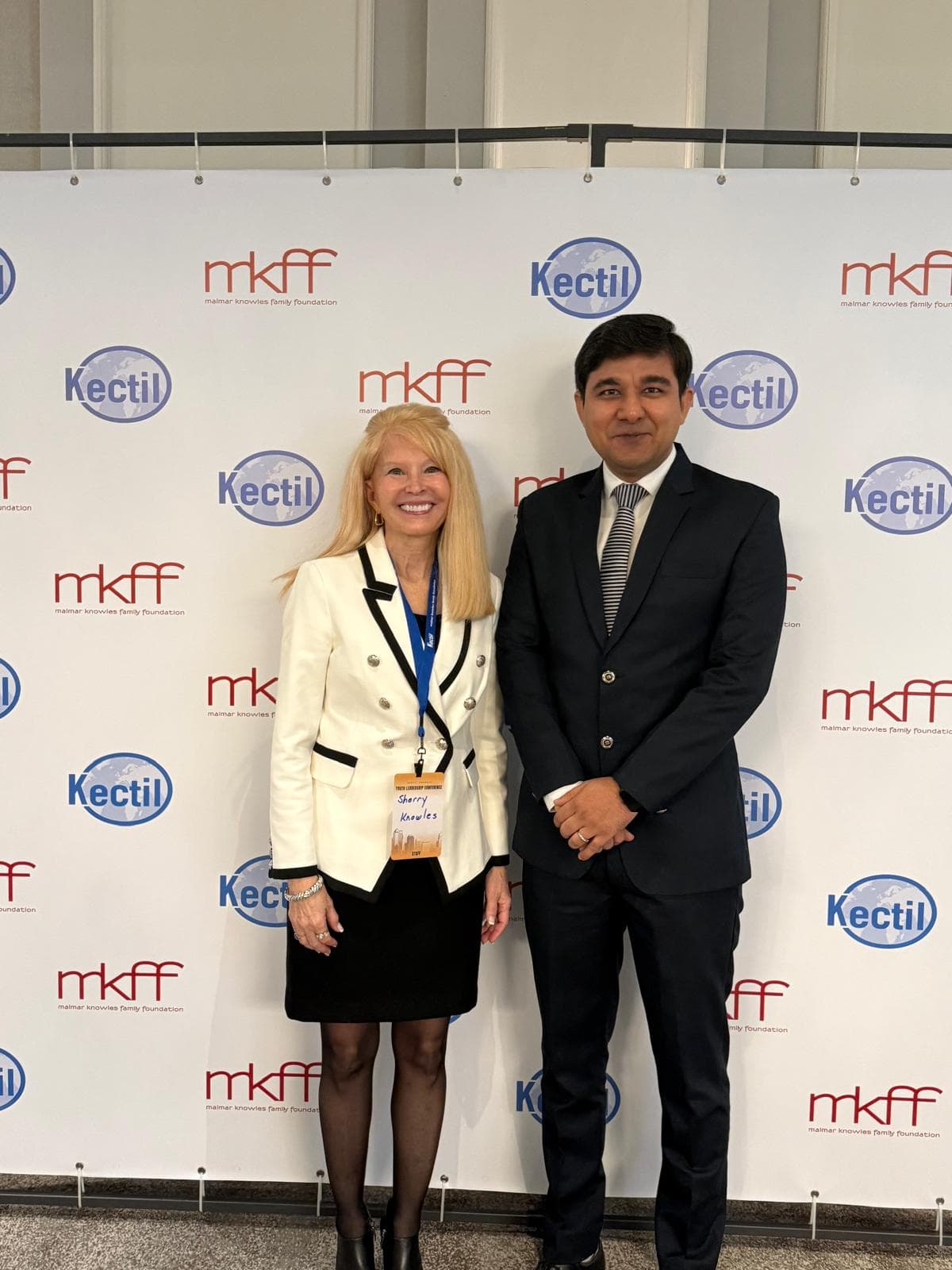 Kectil colleagues standing in front of the Malmar Knowles Family Foundation backdrop.