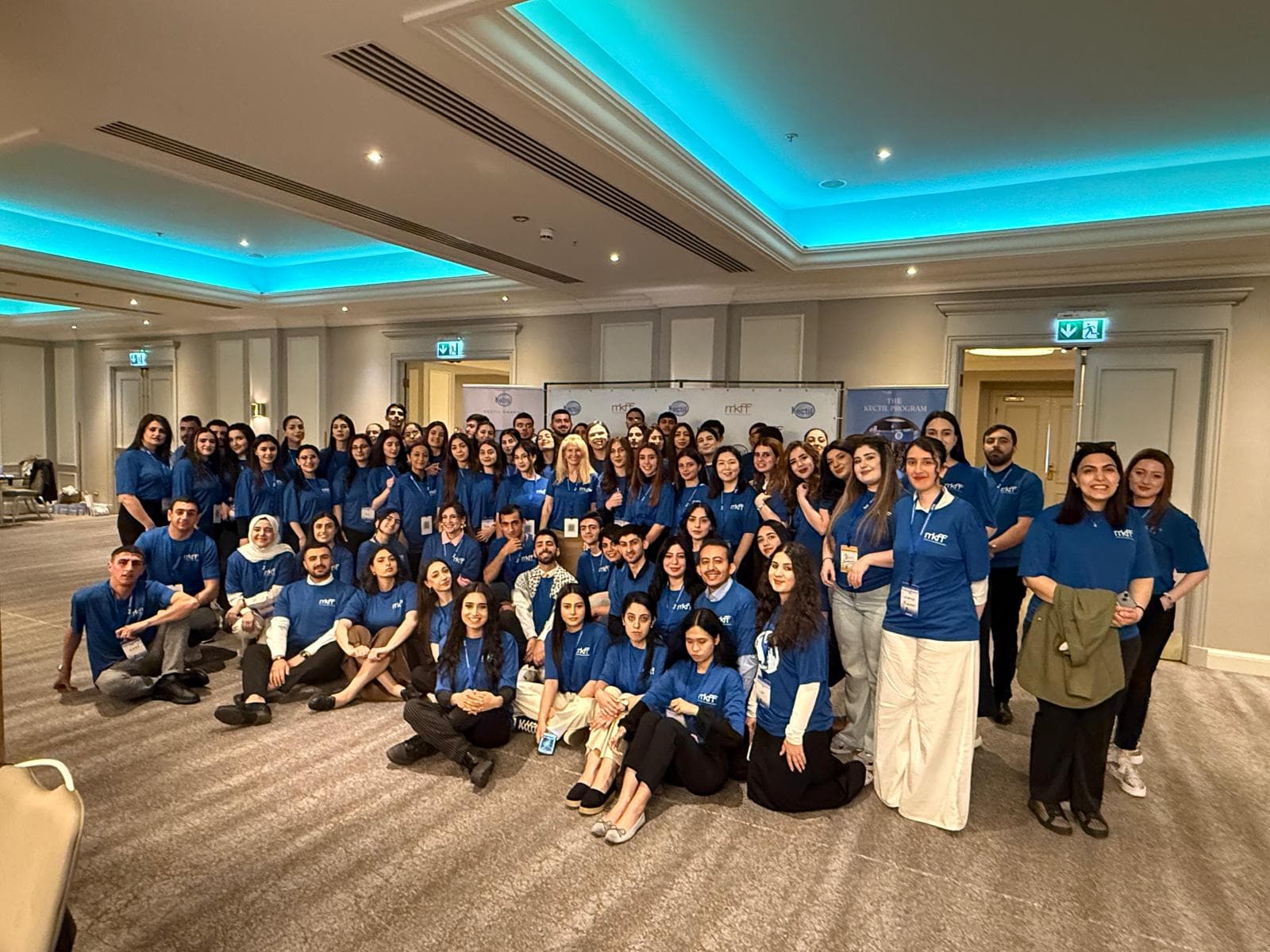 Kectil colleagues in blue program shirts gathered as a cohort.