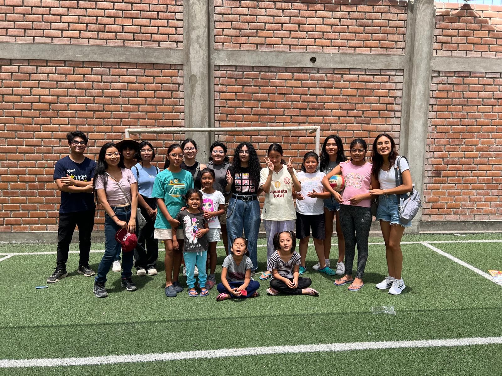 Young people gathered outdoors during a Kectil community project.